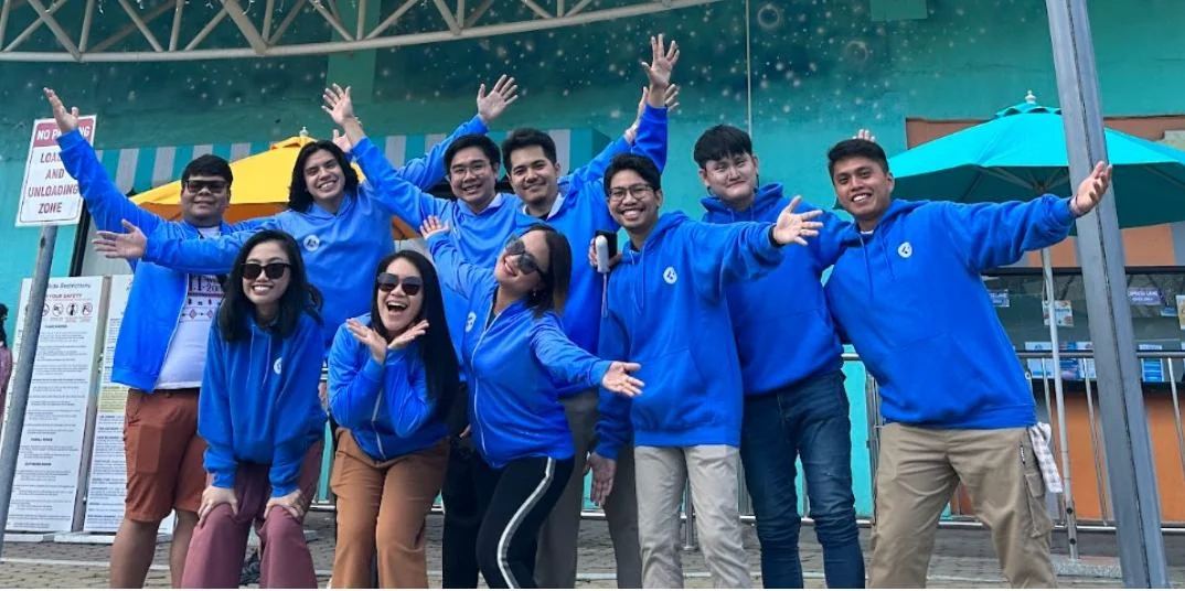 Cortico team celebrating together in blue hoodies